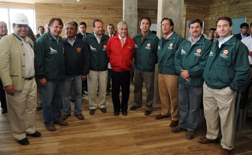 a group of men in green coats are standing together