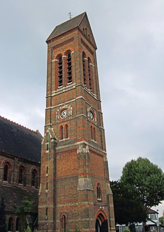 a brick church with a clock tower and a few doors