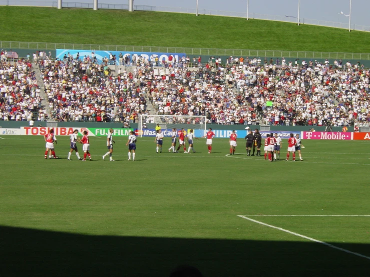 people are watching a soccer game on the field