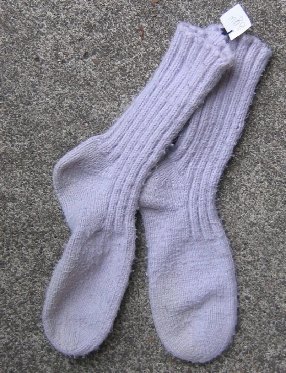 a pair of grey socks that are on the ground