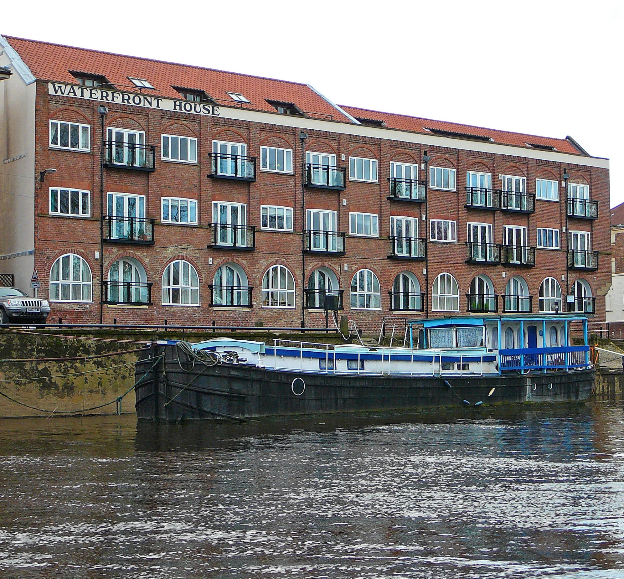 the brick building is on the side of the river