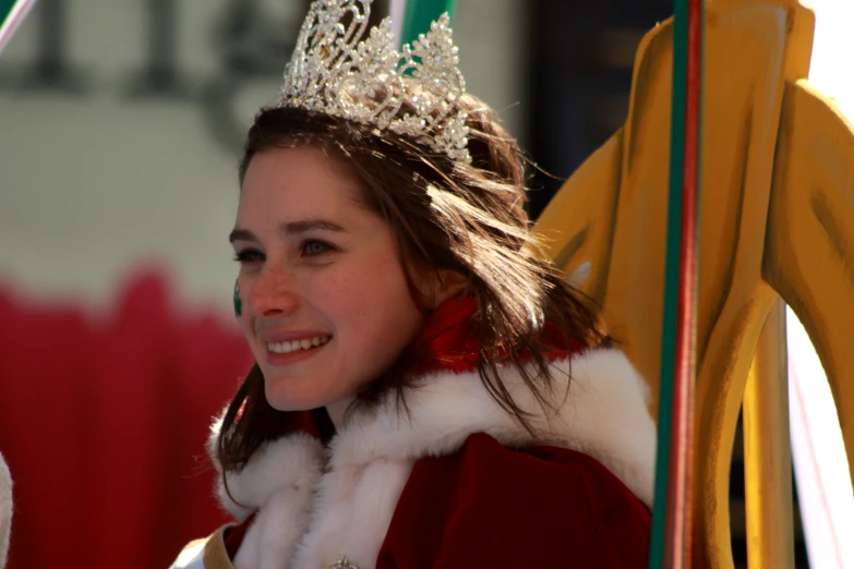 a girl wearing a tiara next to a stage