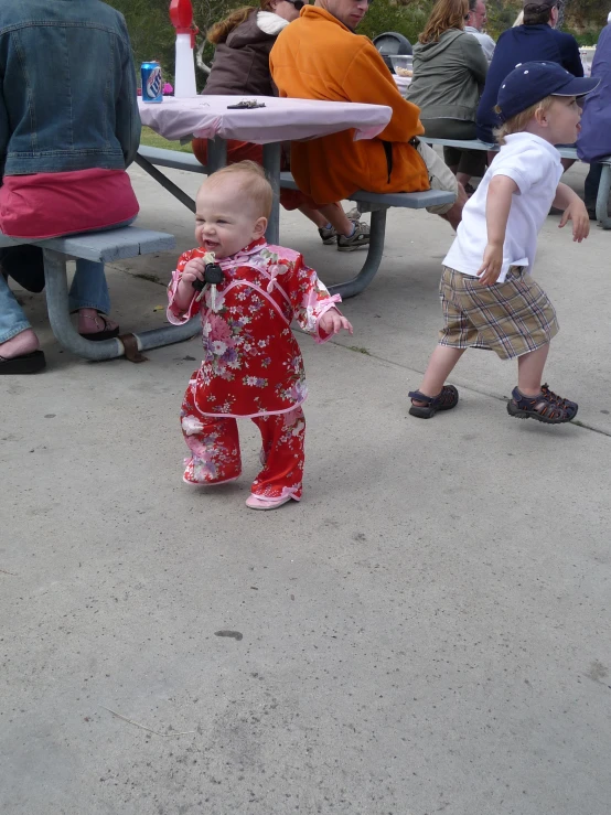 a baby is playing outside with a person