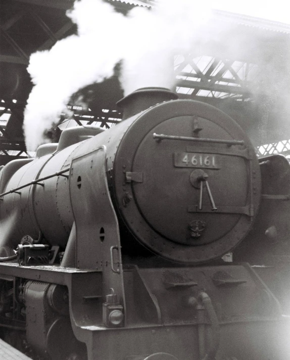 a train blowing smoke next to a loading platform