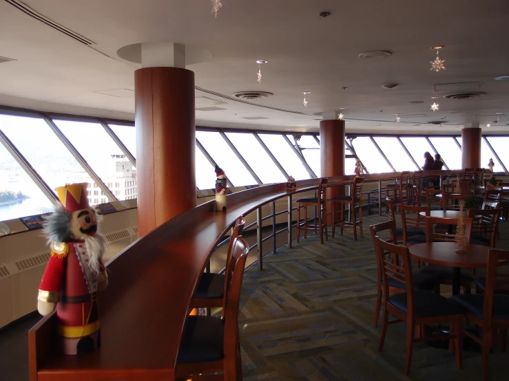 an empty restaurant with a wood bar in front of the window