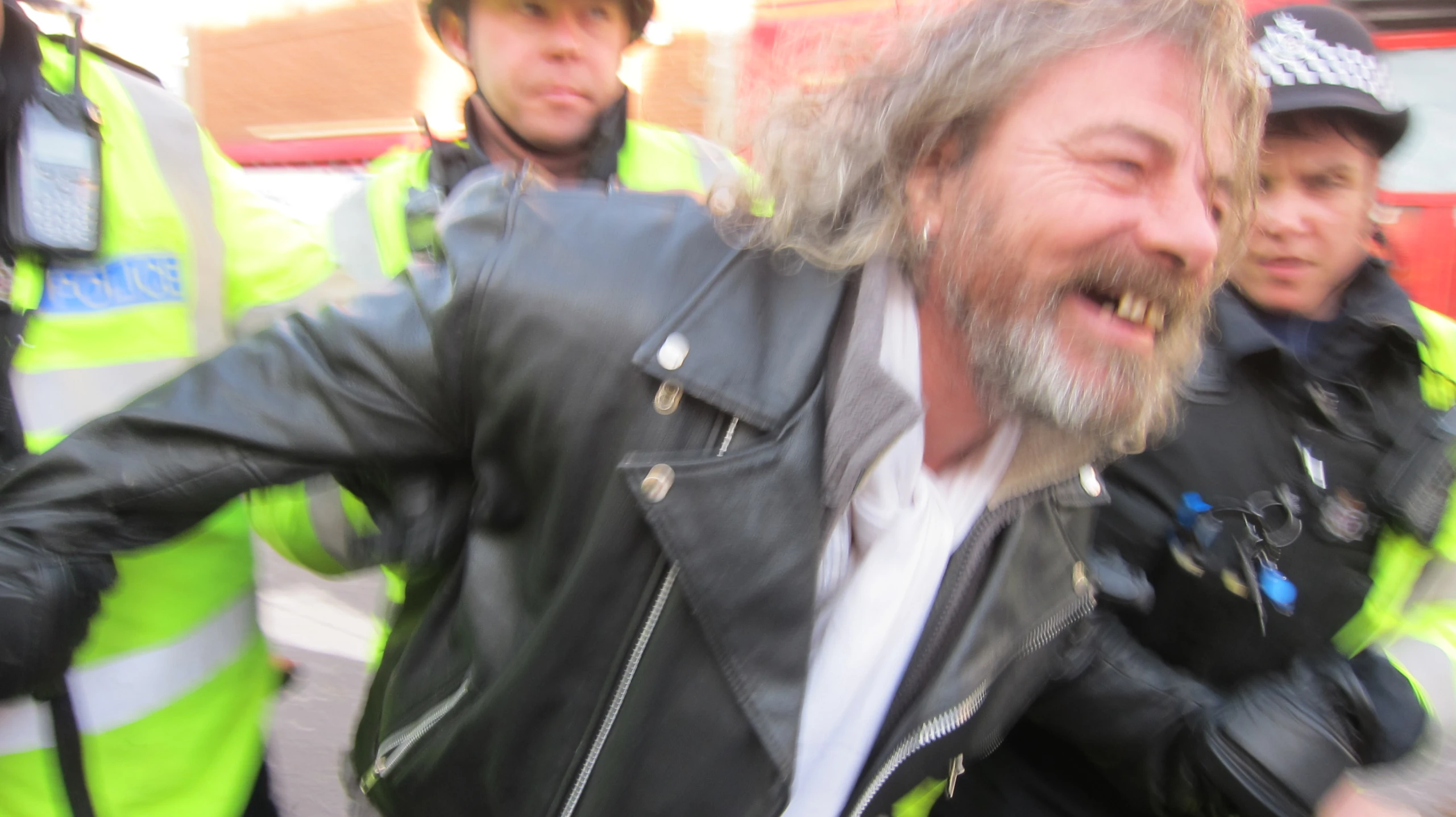 two police officers and a man with grey hair and a moustache