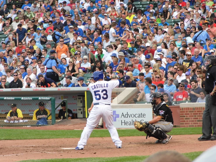 a baseball player holding a bat on top of a field