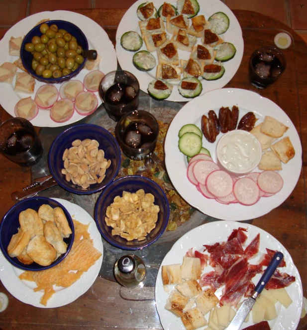 four plates on a table with different food