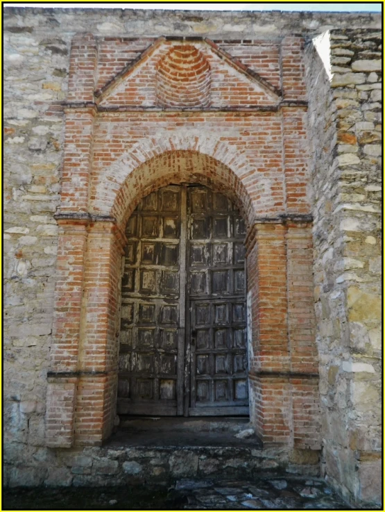 an old wooden door on an old brick building