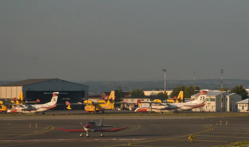 small jet airplanes are parked in a runway