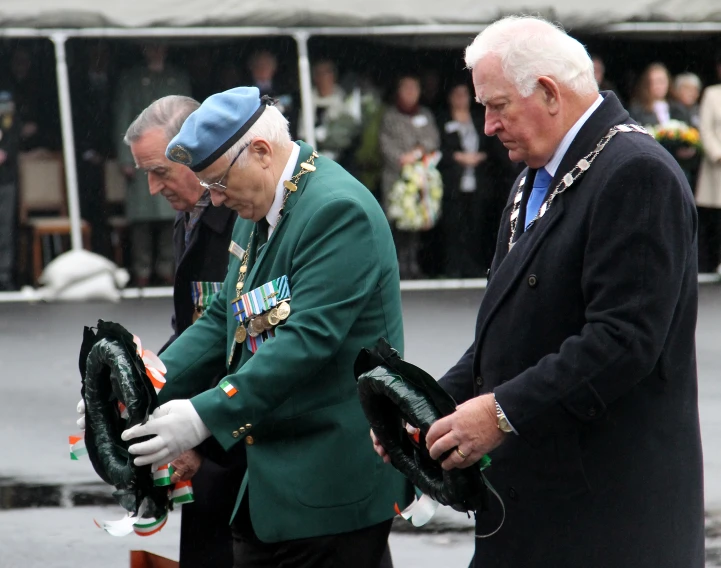 two older gentlemen wearing hats and gloves, one with gloves