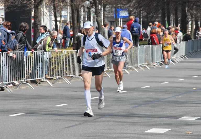 a couple running down a street with lots of people