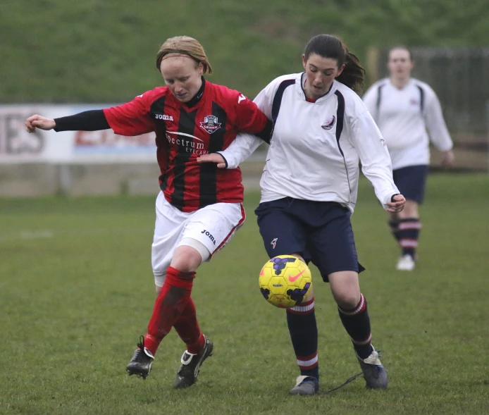 women playing a game of soccer on the field