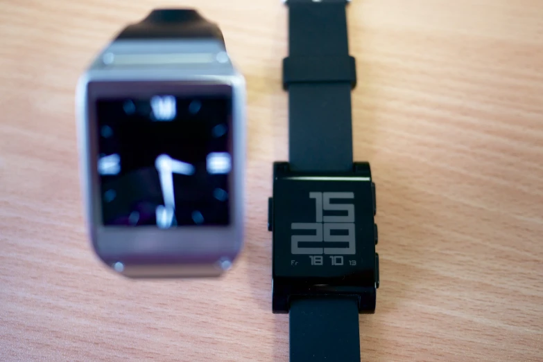 an analog watch next to a phone phone