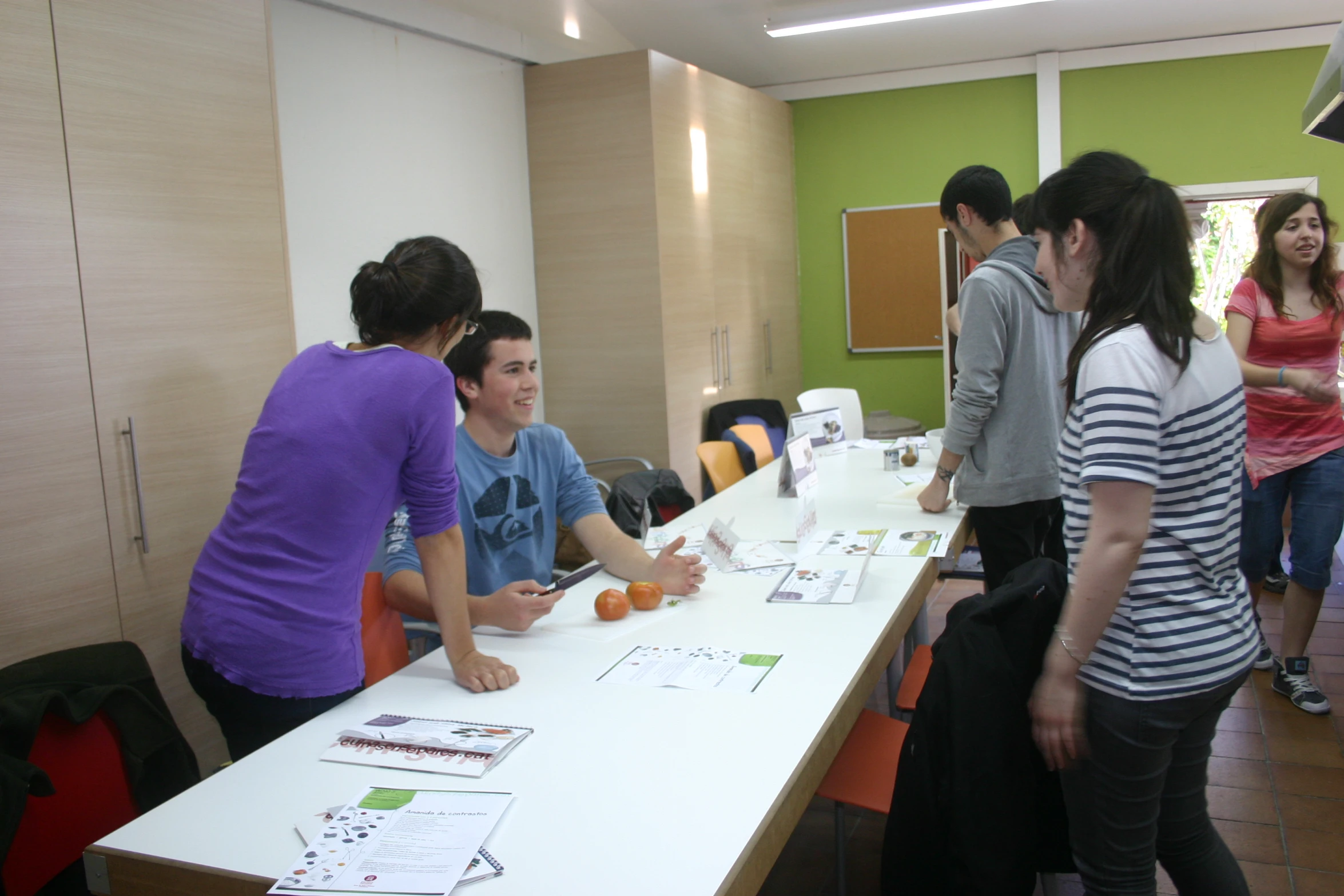 people standing around a long table with note boards