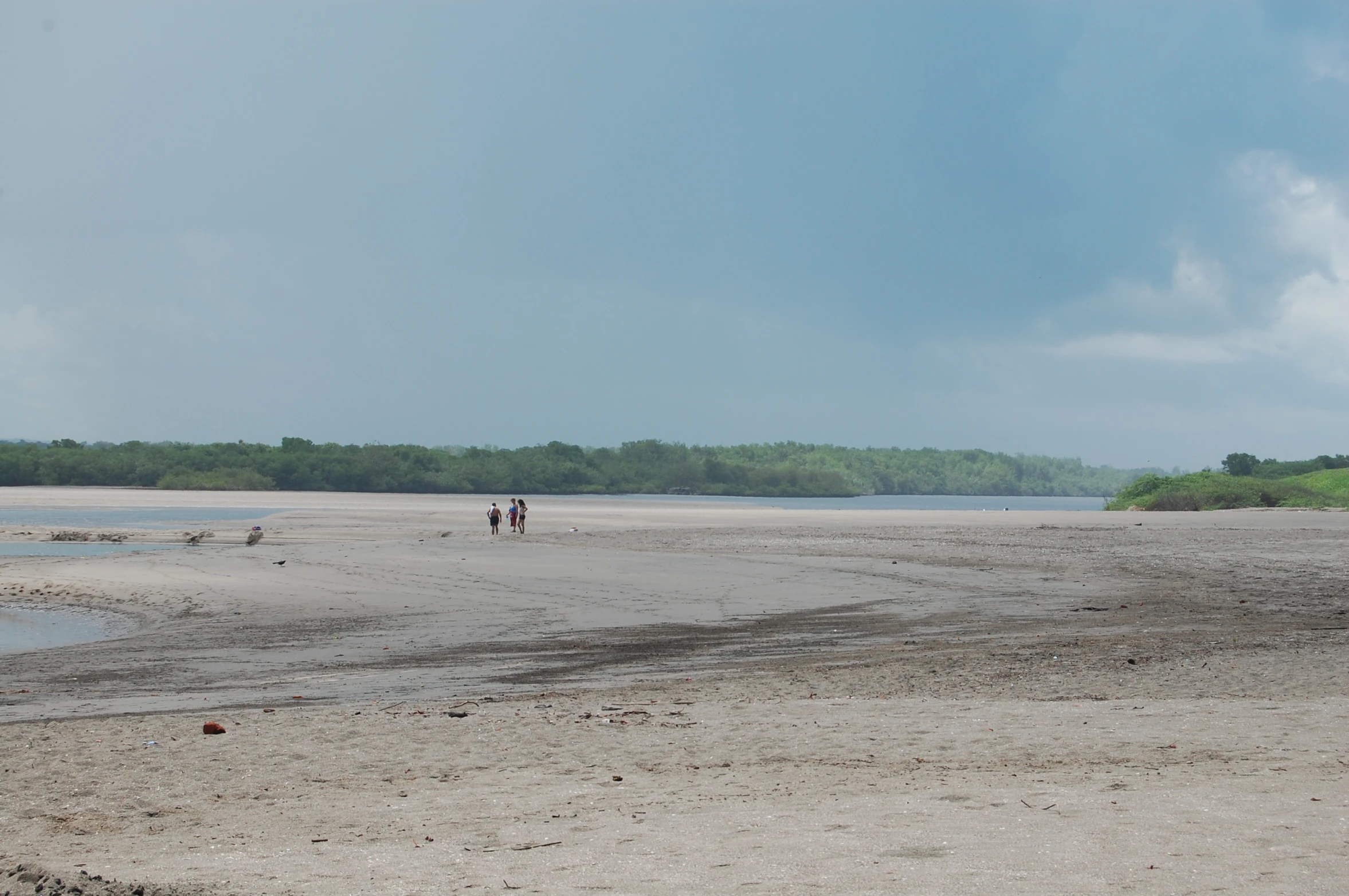 people riding a horse along a wide open area