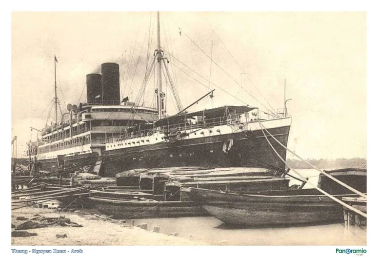 old black and white pograph of ship at dock