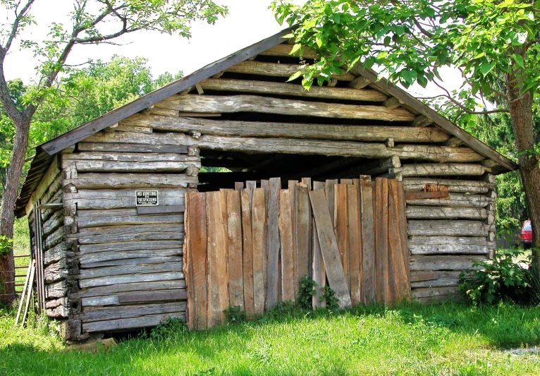 a small building with a wooden fence next to it