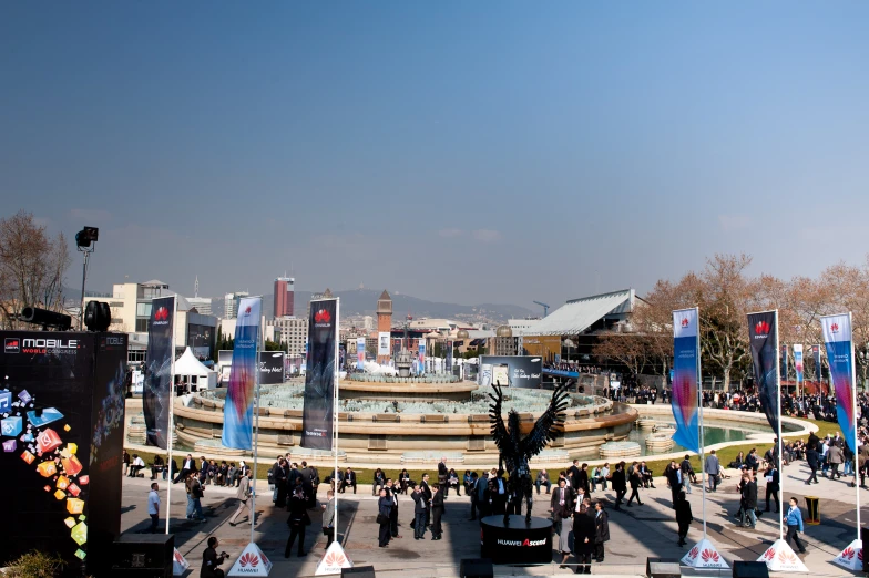 a crowded square with people walking around it