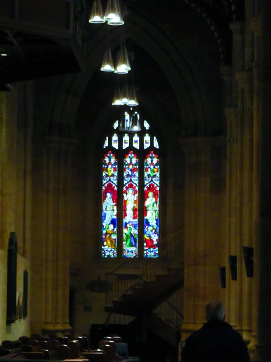 stained glass window of an old church with staircase