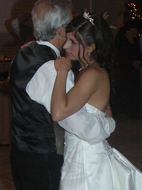 a bride and groom share a first dance