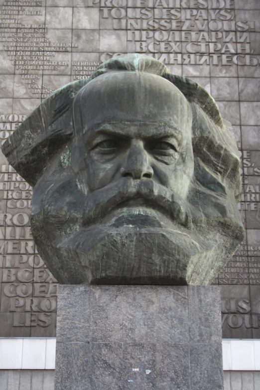 there is a stone sculpture of an old man's head on display