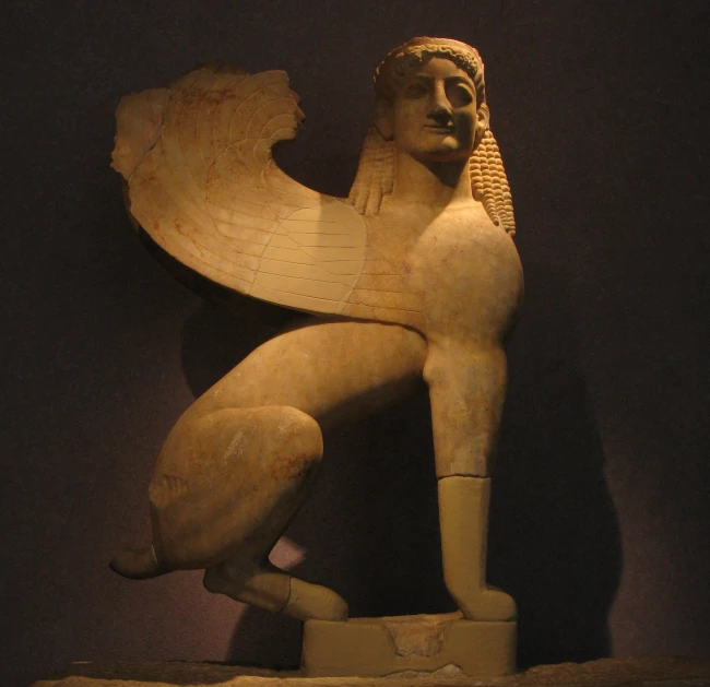 the sculpture shows the woman holding a big object