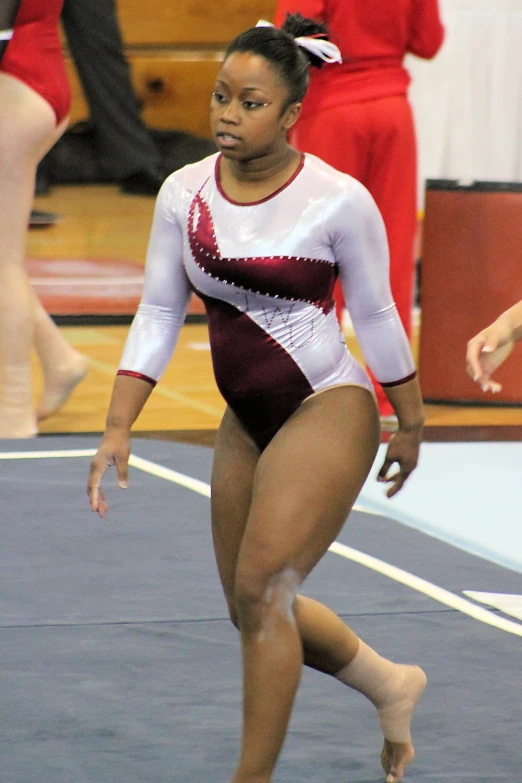 a women who is standing on a gymnastics court