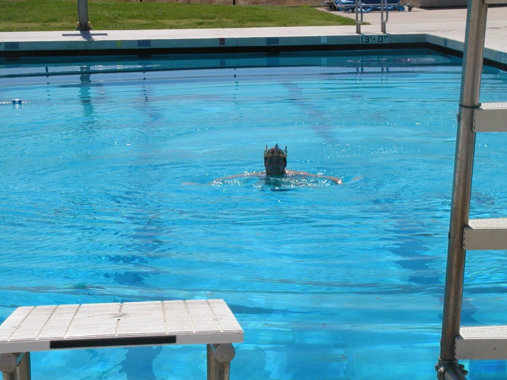 a person is swimming in the pool with a diving device