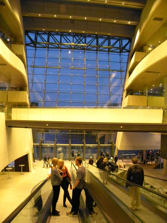 a man and woman riding on an escalator at the airport