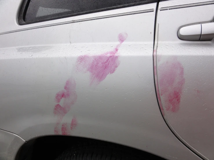 a car's painted rear window with red ink on it