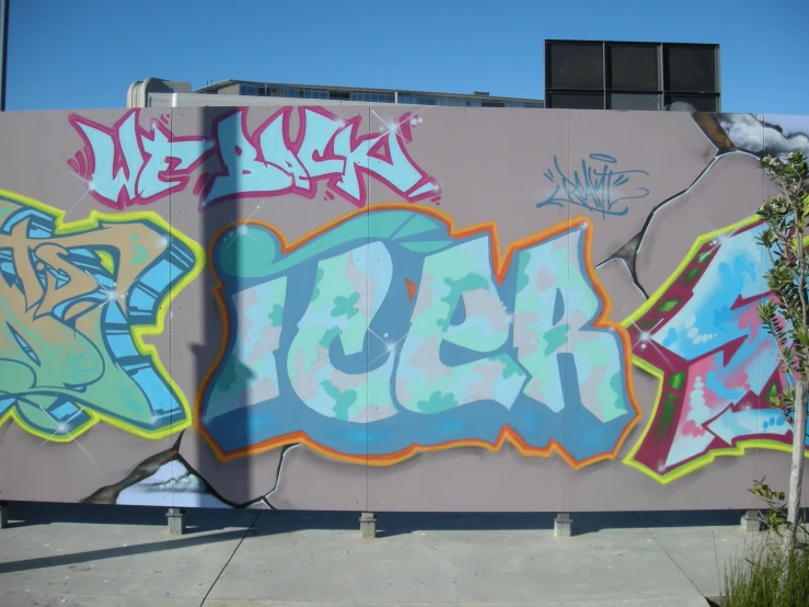 a graffiti wall with some colorful spray paint on it