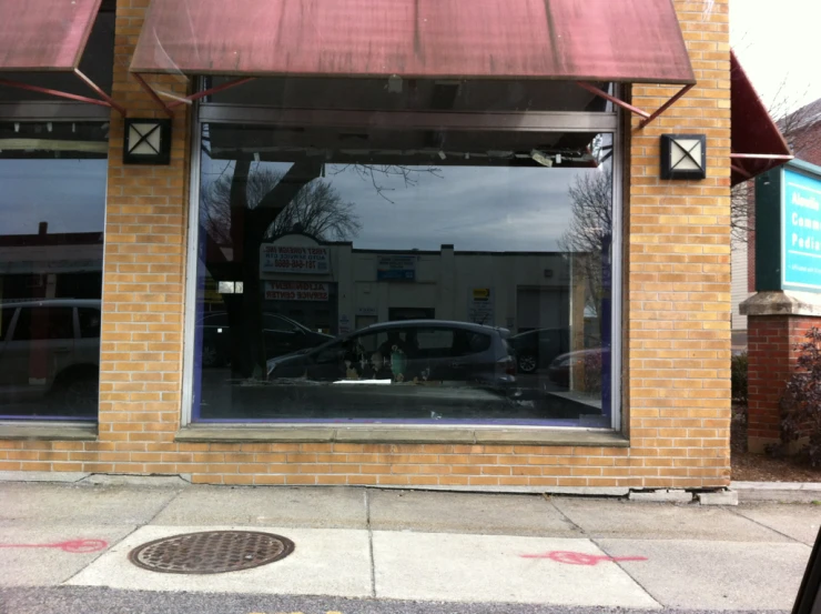 a store with two cars parked outside of it