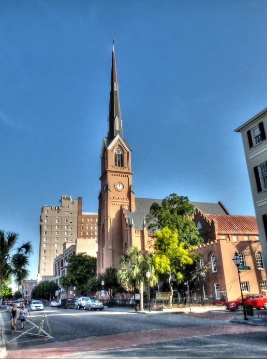 an old church sits behind the buildings of a city