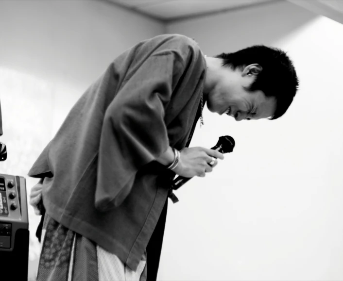 a person in a room holding a microphone