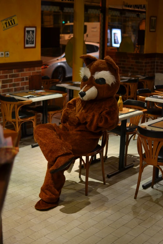 a person in a costume sitting in a restaurant