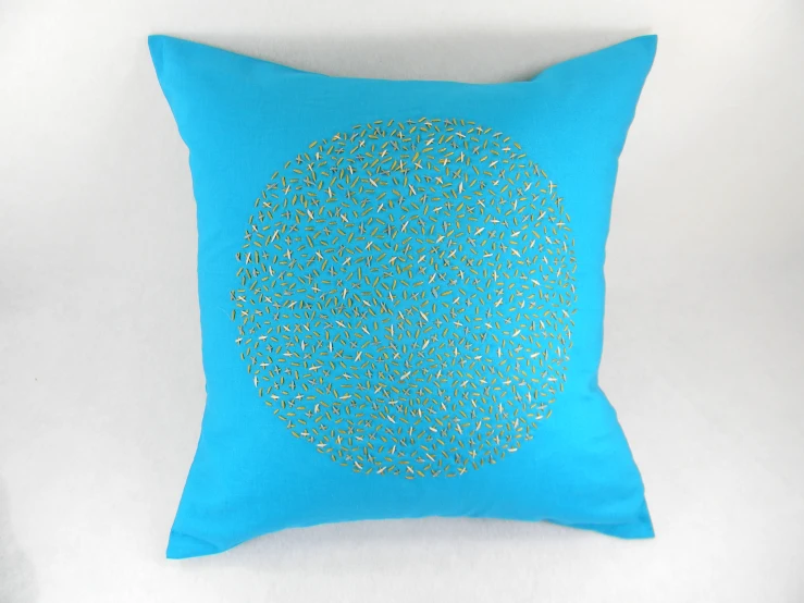 a bright blue square pillow with blue dots