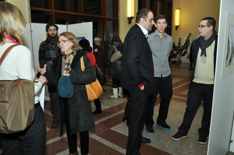 a group of people standing next to each other near a door