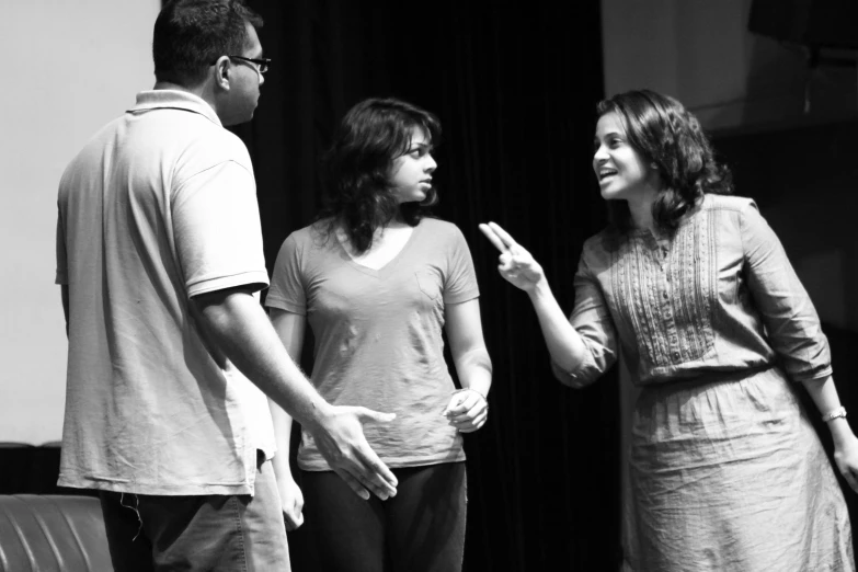 the man and two women are standing together