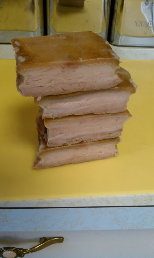 a stack of partially cut meat sits on a table
