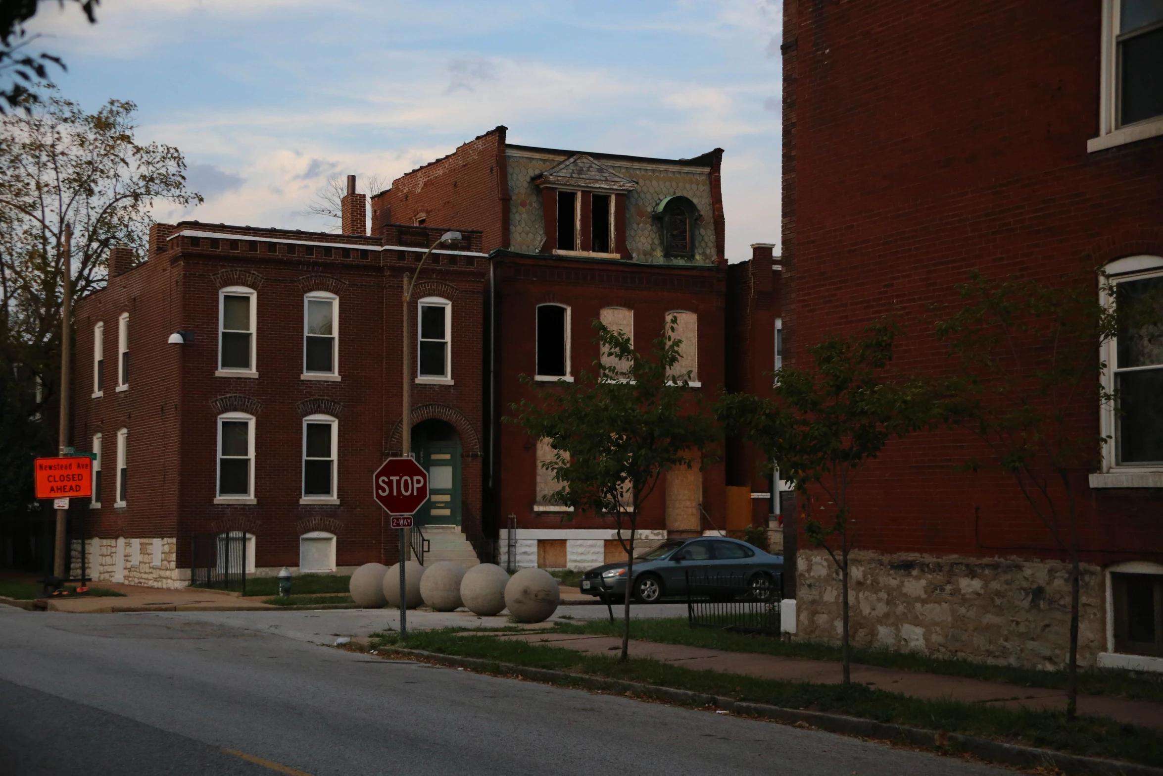 this is an image of the side of the road in front of abandoned buildings