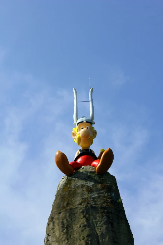 a stuffed animal sitting on top of a rocky hill