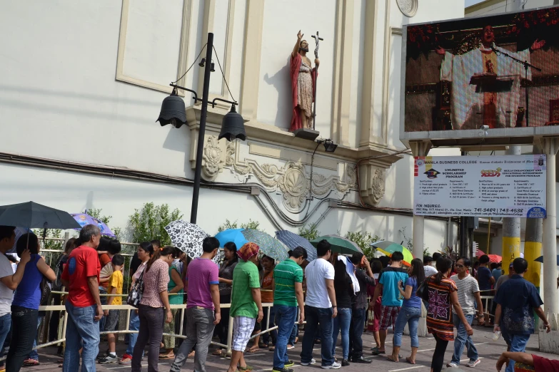 a crowd of people stand outside a theater