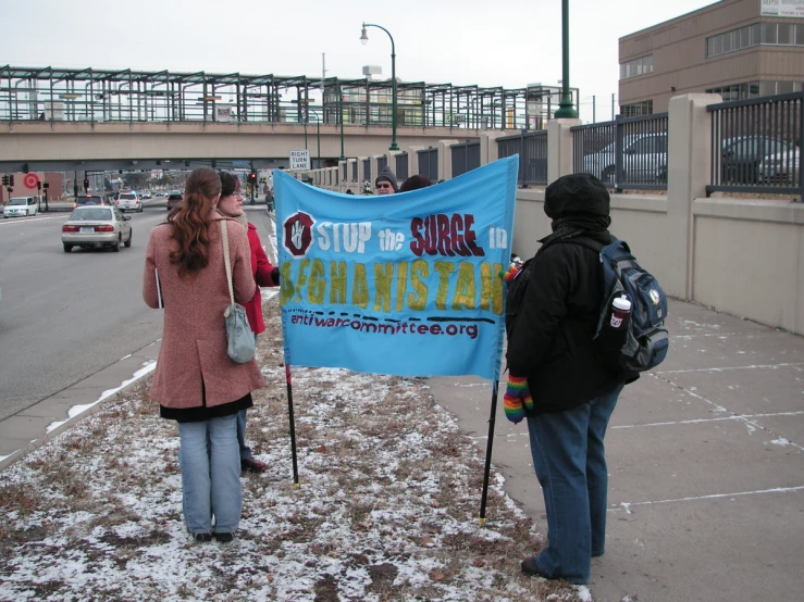 two people in a parking lot standing next to an advertit for the subway