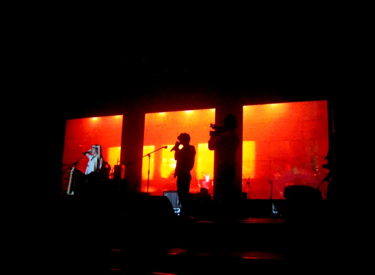 a woman singing on stage with bright lights