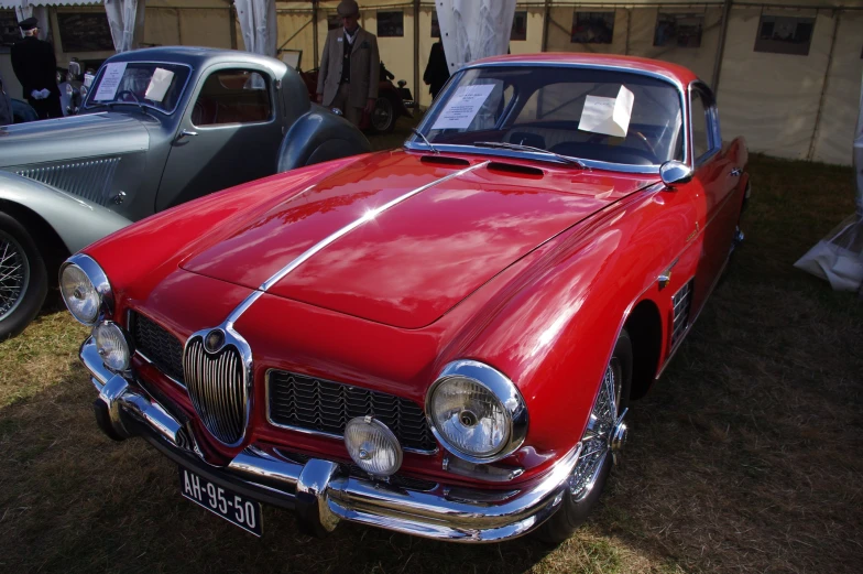 a classic red and chrome sports car on display