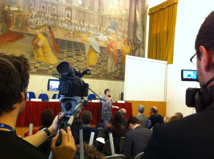 a man and woman taking pictures in front of a crowd