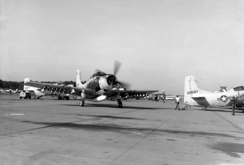 two small planes parked next to each other on a runway