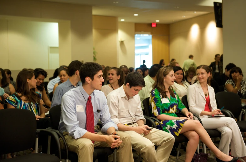 a group of people sitting in chairs in a room