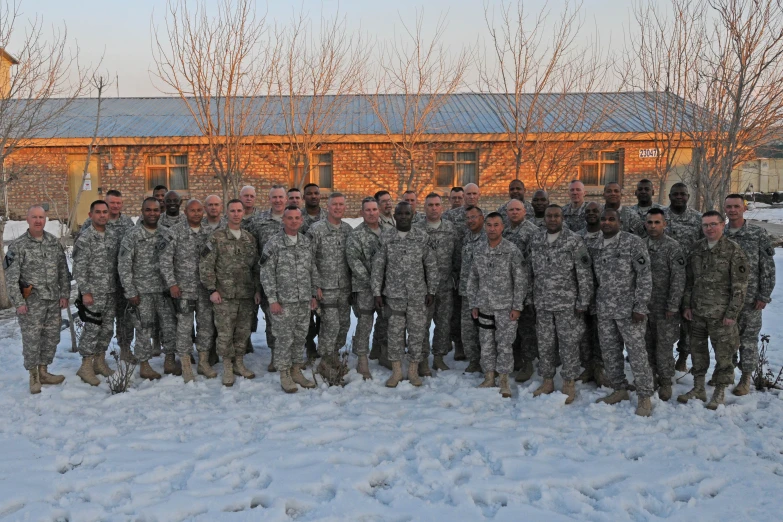 a group of military men standing on top of snow covered ground